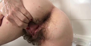Super hairy cougar showing her hirsute asshole up close