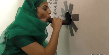 Muslim lady worships strange dicks in a glory hole video