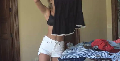 Cute blonde is putting on her clothes while you watch