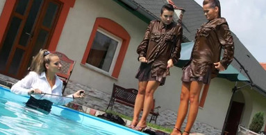 Three girls are clothed and they get wet in the pool