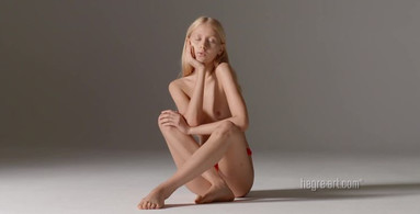 Petite model with cute face is posing nude in a photoshoot