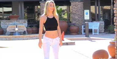 Fit blonde walking around the city without a bra