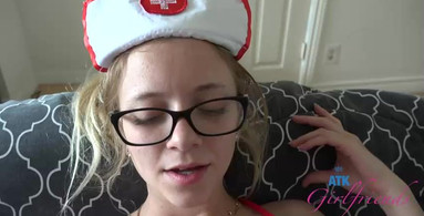 Chick in a nurse outfit giving a footjob and wearing glasses